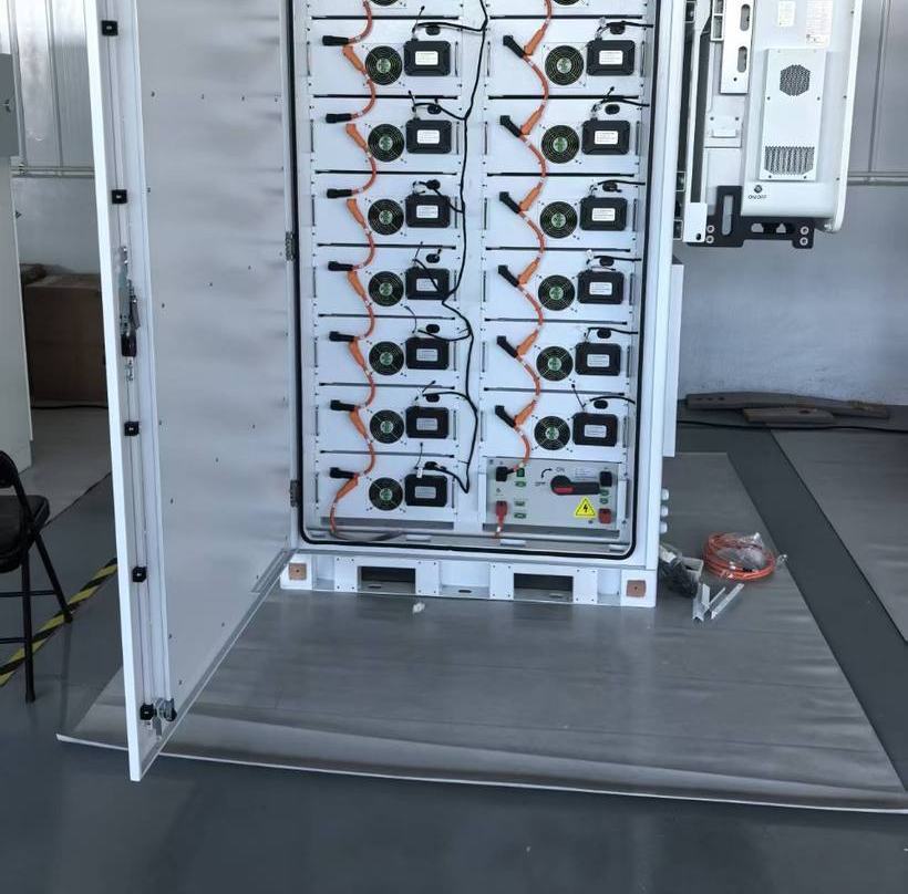 Open cabinet with sixteen battery modules installed and a wall-mounted cooling unit
